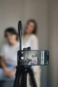 a person taking a picture of a woman on a camera